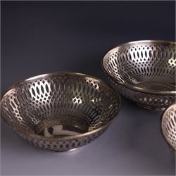 Three 1930s silver bon bon dishes, comprising pair and one larger example, each of circular form with pierced latticework sides, hallmarked Maxfield & Sons Ltd, Sheffield 1936, largest D12cm