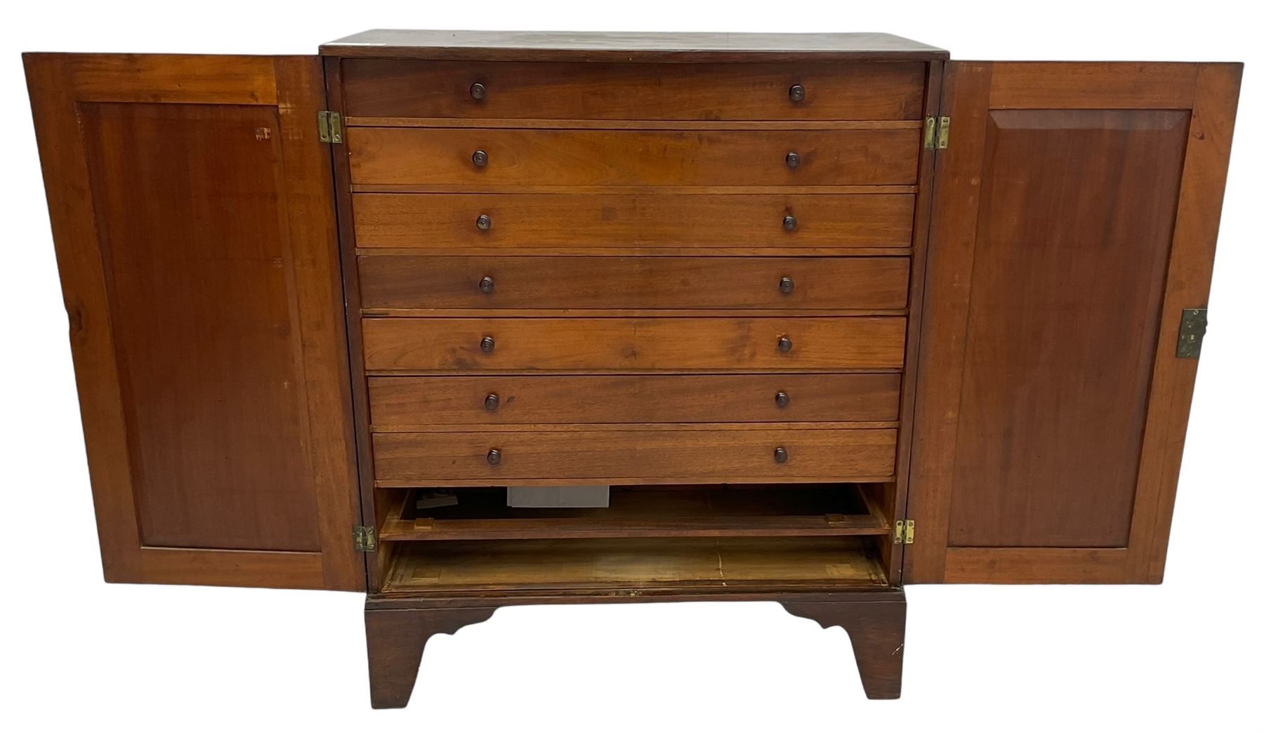 19th century mahogany collector's cabinet, crossbanded rectangular top over two panelled doors, the interior fitted with seven shallow drawers, on bracket feet