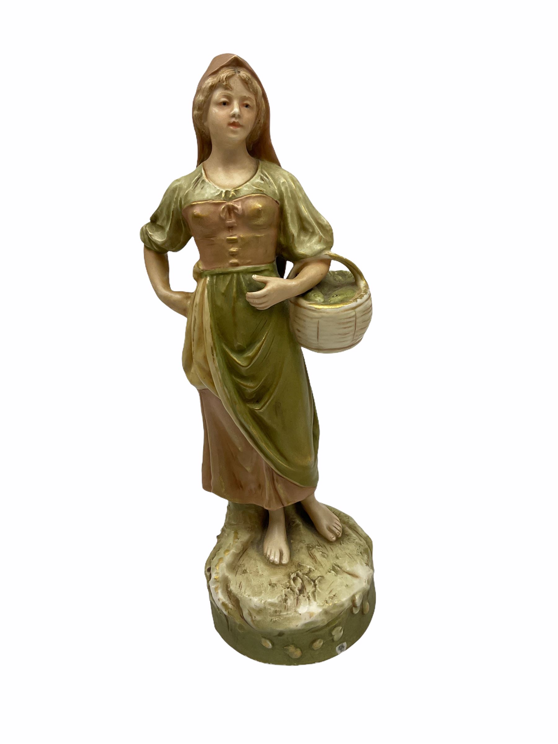 Royal Dux figure modelled as a fish seller, with applied triangle mark to the base and impressed model number 2292, H27cm, together with three Royal Dux style elephants, and a pair of Austrian Turn Wien figures, each carrying 'striker' baskets for matches. 