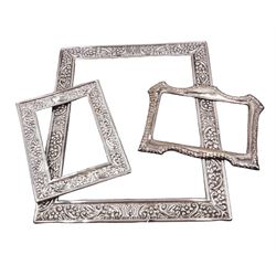 Three modern silver unmounted photograph frames, comprising two of rectangular form, with repousse floral decoration, largest example 31.5cm x 26.5cm, both hallmarked 	Carr's of Sheffield Ltd, Sheffield 1990, together with a rectangular silver frame with shaped rim and repousse chevron border, hallmarked London 1989, maker's mark SS