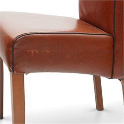 Contemporary round dining table and four orange faux leather chairs