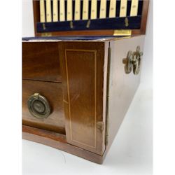 Late 19th/early 20th century composite canteen of silver flatware, contained within an early 20th century mahogany serpentine fronted case with twin drop carry handles, and hinged cover with boxwood stringing and central inlaid shell motif, above a single drawer with twin ring handles and Wellington style locking system, the cover and drawer opening to reveal plaque for Spink & Sons Ltd London, and fitted interior containing ivory handled knives, ivory handled carving set, and silver Hanoverian and Old English pattern cutlery, each with engraved monogram to terminal, hallmarked London, makers Spink & Son (John Marshall Spink), Goldsmiths & Silversmiths Co, and Chawner & Co (George William Adams), various dates ranging 1880-1923, gross weighable silver 92.59 ozt (2880 grams)