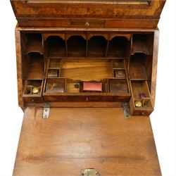 Quality George I figured and burr walnut bureau-cabinet of unusually small proportions, the projecting cavetto cornice over a glazed and banded door enclosing four adjustable shelves, with a candle slide below, the book-matched and banded veneer fall-front enclosing a fitted interior with pigeonholes, correspondence drawers and original trinket boxes and inkwells, over two pull-out stays and four graduating long drawers with banded facias and pressed brass escutcheons and pull handles, lower moulded edge on bracket feet
Provenance: purchased Sotherby's 1977