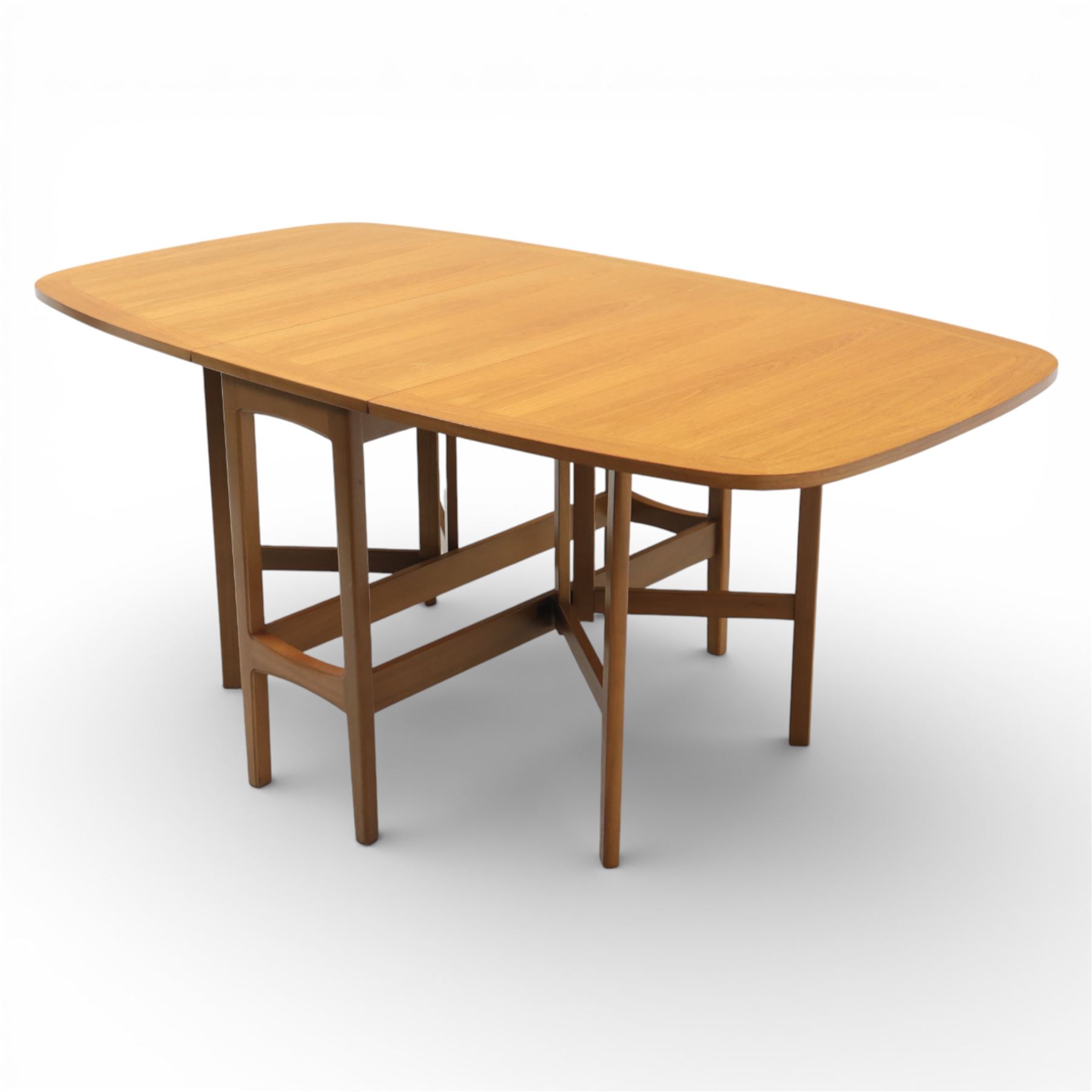 Nathan - teak drop leaf dining table, the rectangular top with rounded corners fitted with twin hinged drop leaves and gate legs, extended to form an oval table 174cm in length, raised on square section supports united by stretchers