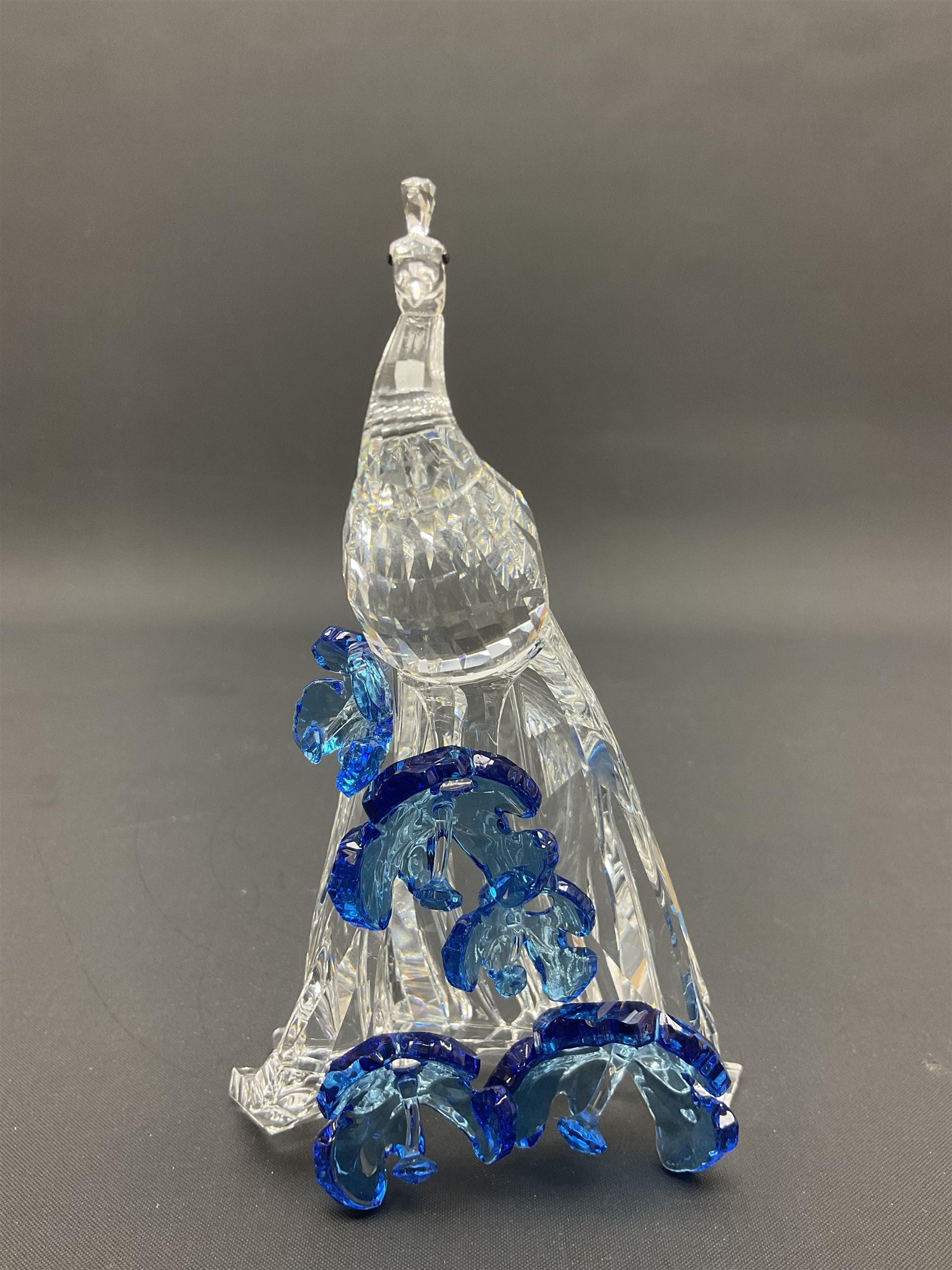 Swarovski Crystal animals, comprising white peacock, the tail with cascading blue flowers, perched eagle with yellow beak, ibex with frosted crystal horns and unicorn with frosted crystal horn, tallest H13cm
