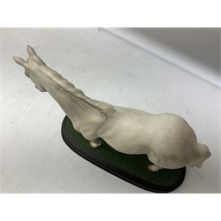 Three Beswick horse figures, comprising large racehorse in bay no. 1564, Desert Orchid on wooden plinth no. DA184and Red Rum on a wooden plinth no. A226, all with printed mark beneath 