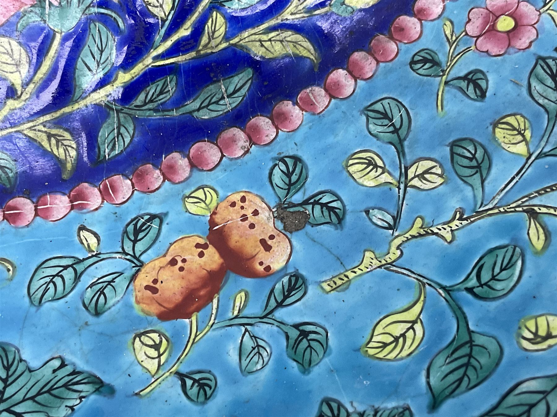 18th/19th century Chinese Canton enamel basin, the circular basin with flat everted rim, decorated with scrolling foliate and fruit decoration on a blue ground, D43cm