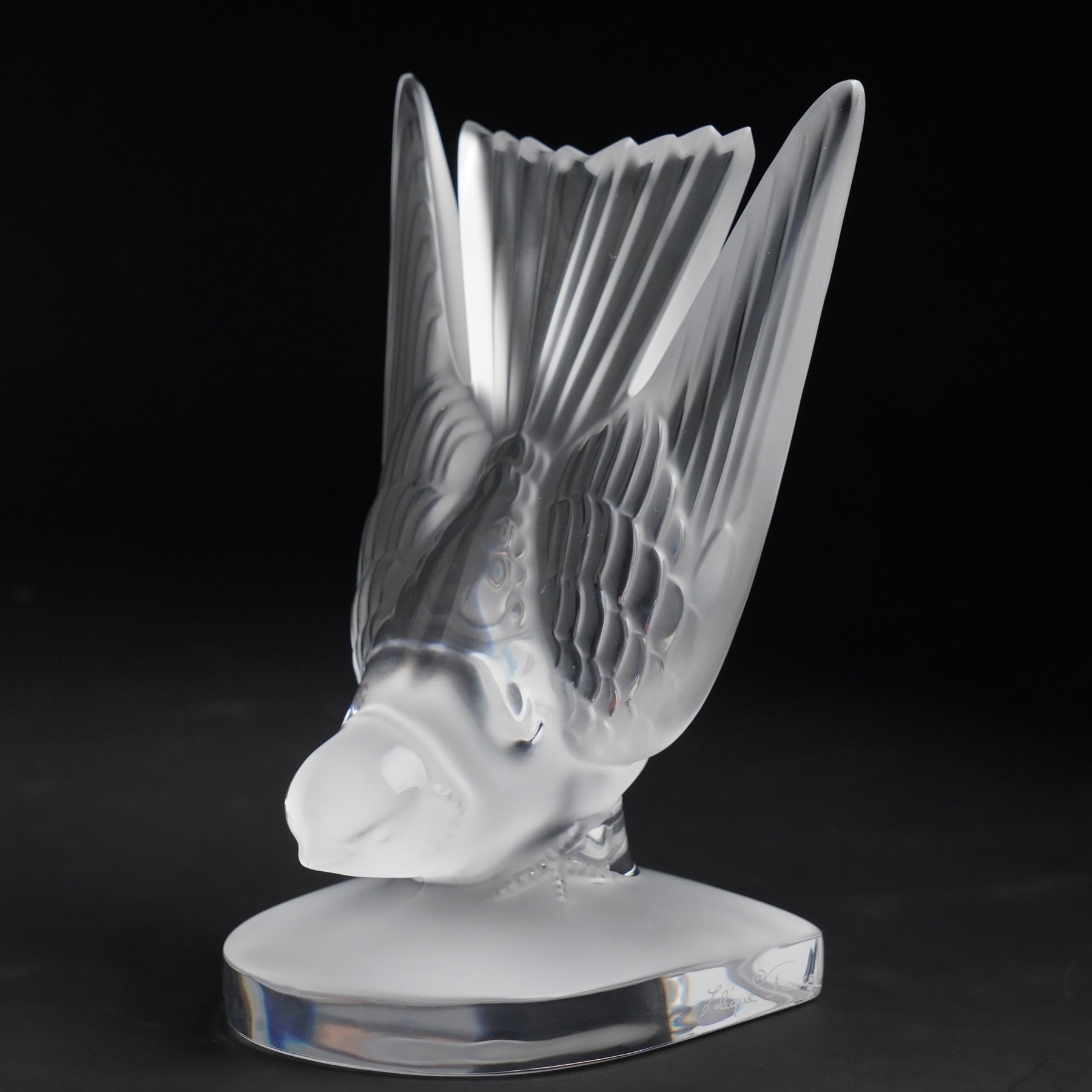 Lalique model of a swallow frosted glass bookend, inscribed 'Lalique France' H15.5, and 'pivoine' scented candle in box (2)