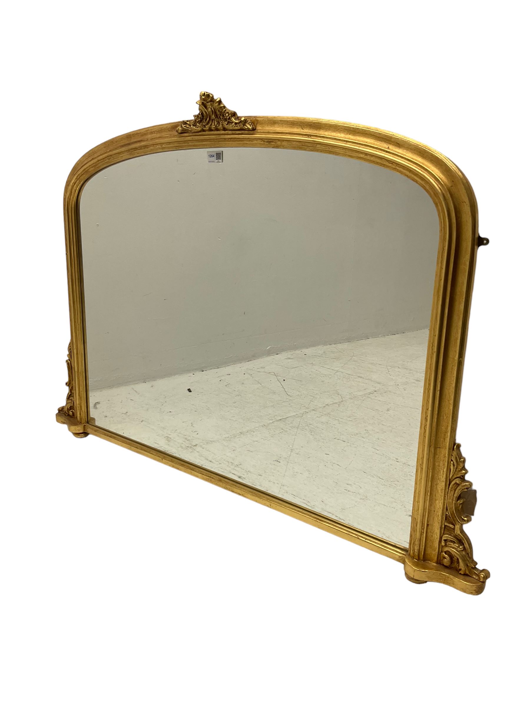Victorian design gilt overmantel mirror, moulded arched frame with scrolled foliage cartouche pediment and brackets 