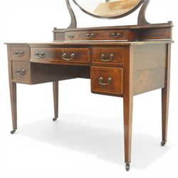 Edwardian mahogany dressing table, rectangular top above a central kneehole drawer flanked by two short drawers over two graduated drawers to each pedestal, raised superstructure with three small drawers and oval swing mirror on shaped supports, on square tapering legs with castors