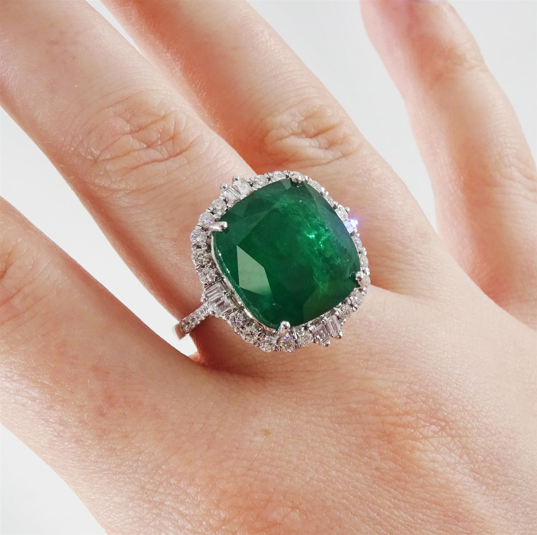 18ct white gold emerald and diamond cluster ring, single cushion cut emerald of approx 13.20 carat, with round brilliant cut and baguette cut diamond surround and shoulders, stamped, total diamond weight approx 0.80 carat