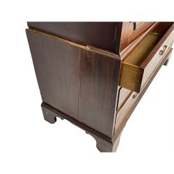 George III mahogany linen press, projecting cornice over two figured doors enclosing five linen slides, the lower section fitted with two short and two long drawers, on bracket feet