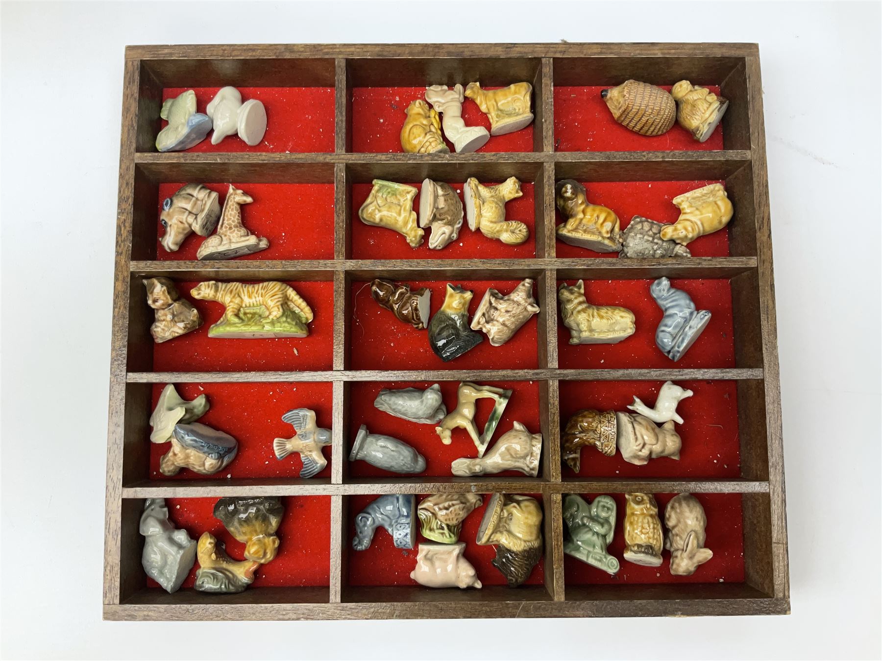 Collection of whimsy figures in a wooden display case, together with other assorted collectables, including stamps, pin badges etc