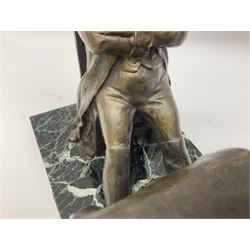 After E Carlier; a bronzed spelter desk stand as Napoleon seated with arms crossed at a table with maps, books and aperture for a lamp, on marble base with plaque entitled 