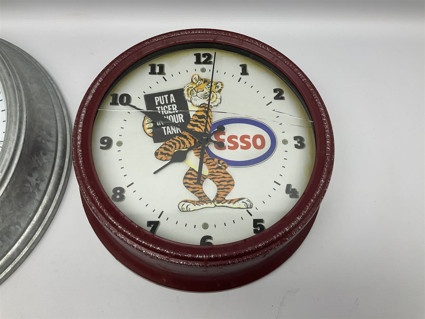 Esso Advertising Wall Clock, 'Put A Tiger In Your Tank', together with Jones & Co wall clock, largest example D40cm