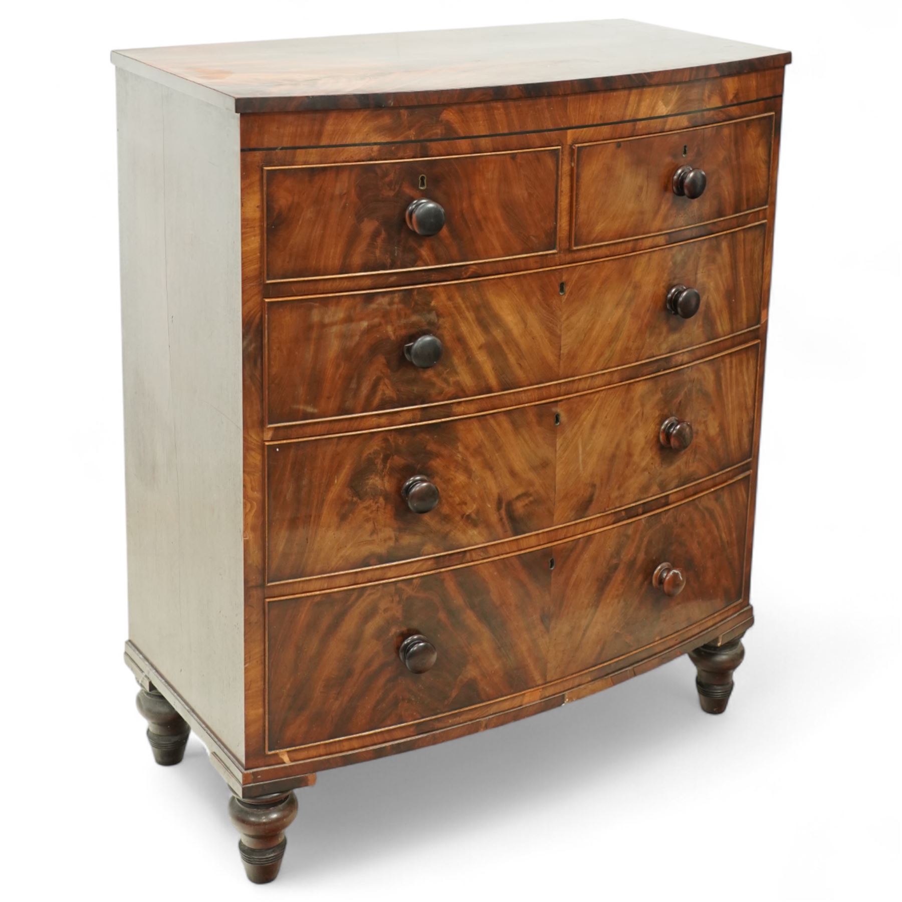 19th century mahogany chest of drawers, bow fronted form with two short over three long drawers, each veneered in matched flame mahogany, on turned feet