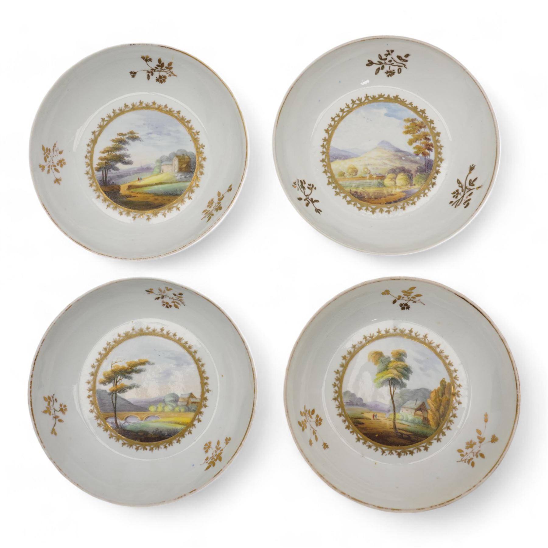 Set of four Pinxton porcelain bute shaped teacups and saucers, circa 1796-1813, pattern no. 58, painted in polychrome with circular landscape panels within gilt husks and sprigs, all saucers numbered 58 beneath, saucer D14cm, teacup H6cm (8)