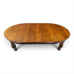 Late 19th century French oak extending dining table, oval top with moulded edge and plain frieze, raised on four ornate carved supports decorate with carved latticework and large festoons with tassels, on turned feet, with two additional leaves