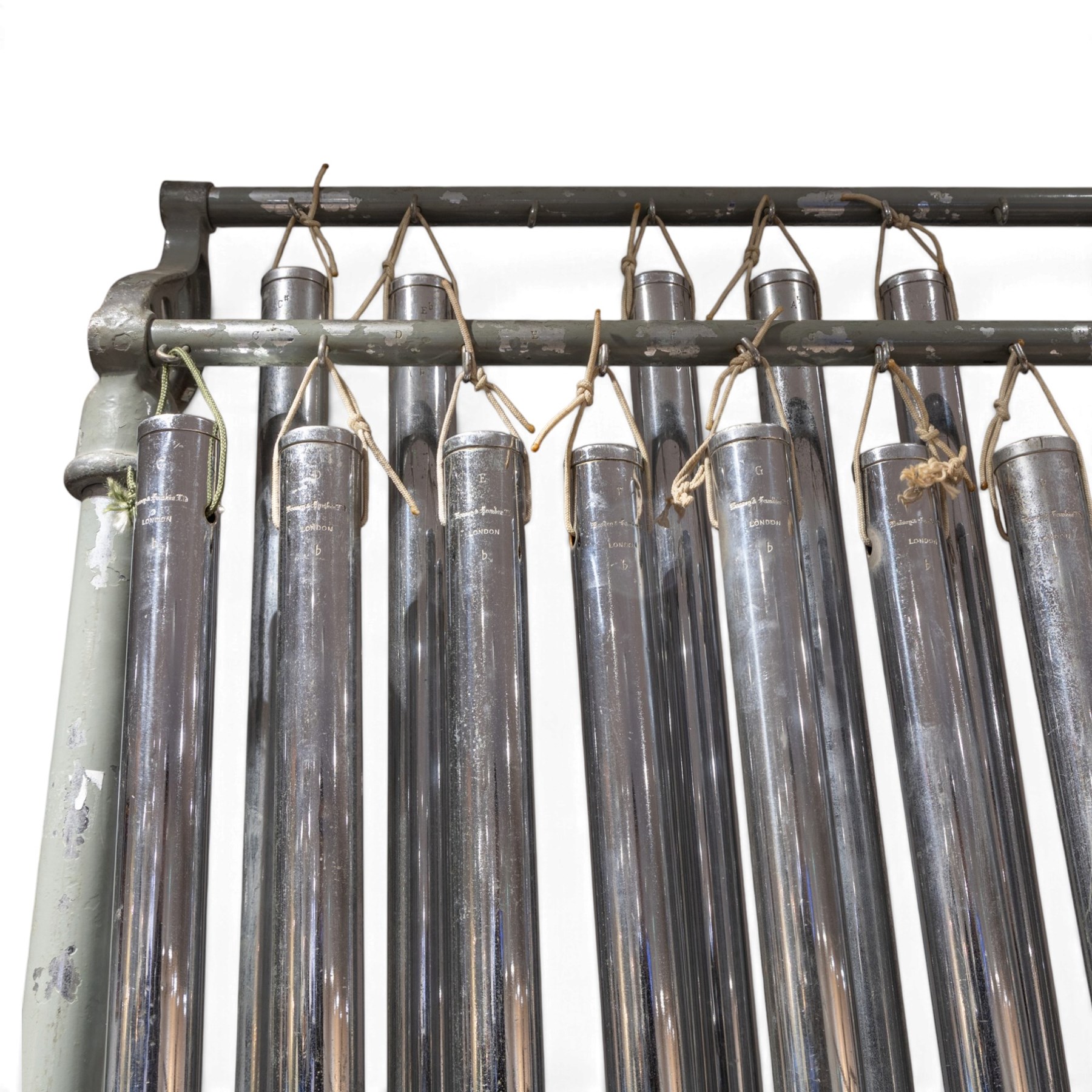 Boosey & Hawkes Ltd, London orchestral tubular bells/chimes, the chromed tubes pitch-marked and suspended on painted metal frame, frame H186cm