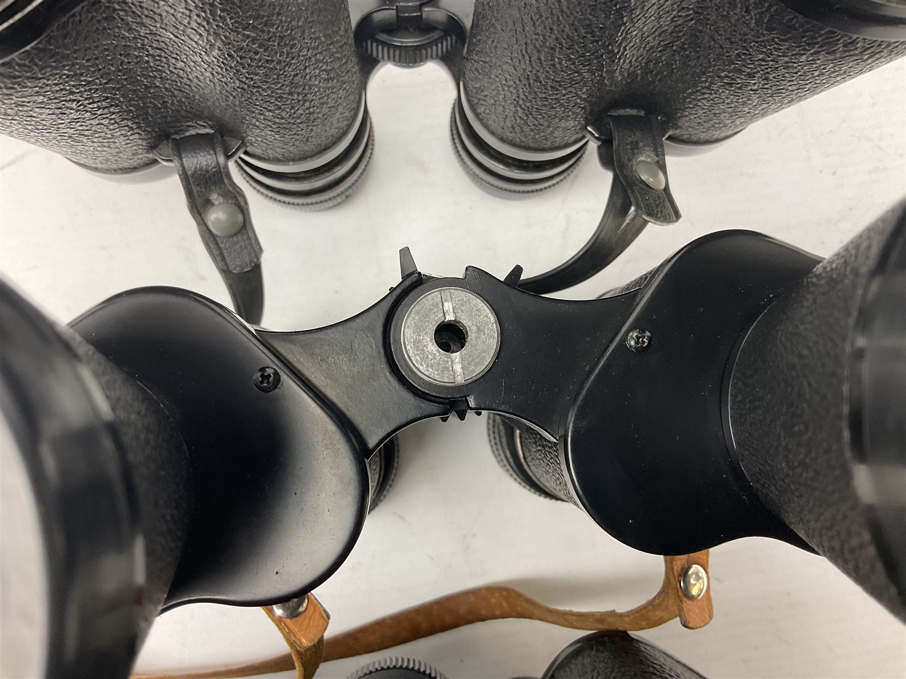 Eleven pairs of binoculars to include Lieberman & Gortz 20x65, Stem (USSR) 7x50, Helios 10x50 Field, Prinz 12x50, Tasco 8x40, Tasco 10x50, etc