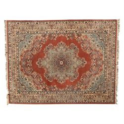 Persian Kashan rug, the rich terracotta field with central floral medallion and palmette s...