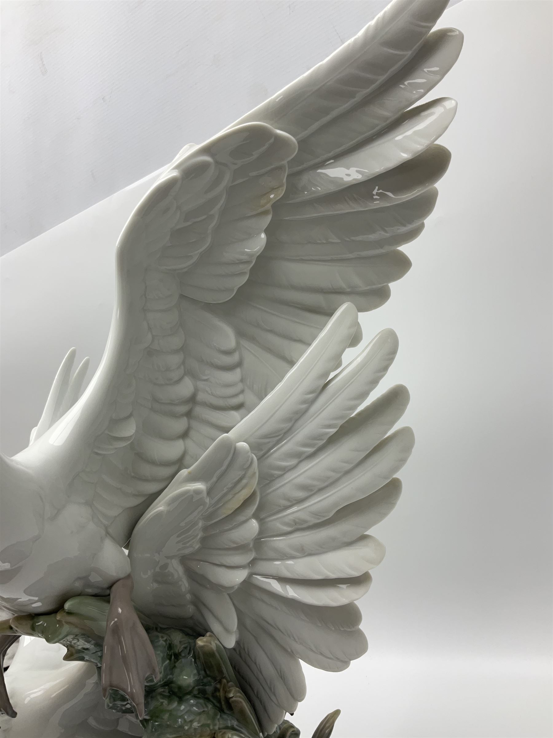Large Lladro figure group, Swans Take Flight, modelled as two swans upon raised on circular wooden plinth, sculpted by Salvador Debon, H68cm