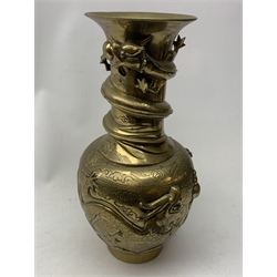 A large Chinese brass vase, of ovoid form with tall neck and flared rim, decorated in relief with dragons chasing a flaming pearl, and further incised with clouds and other detail, the base with relief dragon detail and character mark, H41