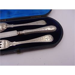 Victorian silver cutlery set, comprising knife, fork and spoon, all profusely engraved with flower heads, each with initials terminals, hallmarked Chawner & Co Birmingham 1877, contained within tooled leather, velvet and silk lined fitted case