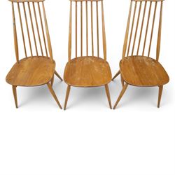 Ercol - 'Goldsmith' light elm set of four dining chairs, shaped cresting rail above seven spindles, dished seat raised on tapering supports with H-stretcher