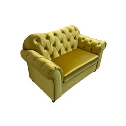 Chesterfield shaped snuggler sofa, upholstered in buttoned gold fabric, with scatter cushions