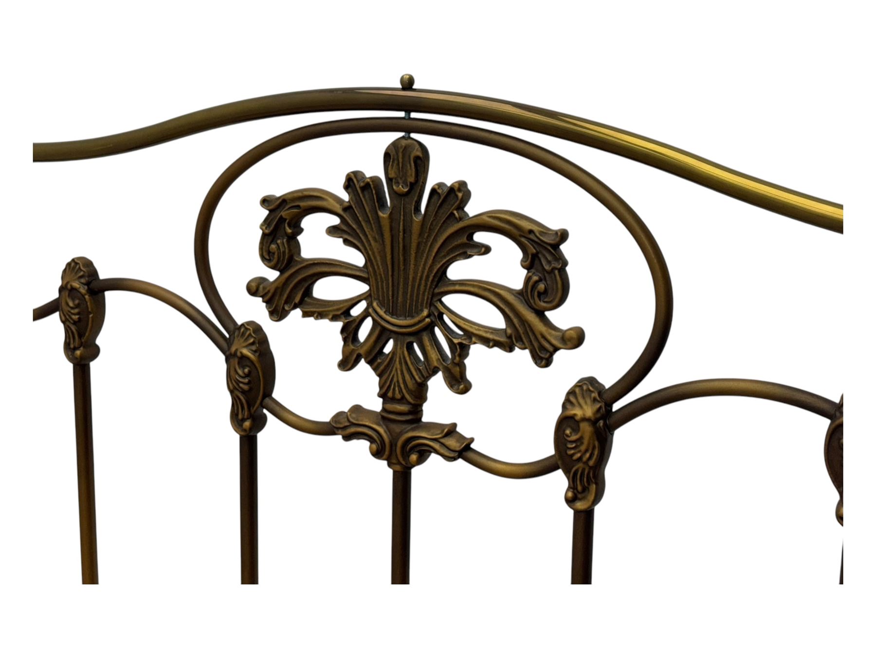 Victorian design king size brass bed frame, featuring an arched headboard and footboard with intricate cast floral and scrollwork centre motifs, flanked by cylindrical supports with ball finials and decorative collars, raised on rounded feet, with a slatted wooden base