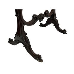 Late 19th century mahogany fire screen, the carved cresting rail with a central cartouche flanked by trailing scrolls surrounding the glazed screen enclosing peacock feathers, the middle rail with further scrollwork and scalloped patterns, raised on shaped end supports with splayed and scrolled cabriole feet on castors