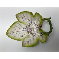Chelsea leaf shaped dish, circa 1756, with a naturalistically modelled green stalk handle and painted with a central rose floral spray and sprig upon puce veins and shaded green rim, with red anchor mark beneath, W20cm