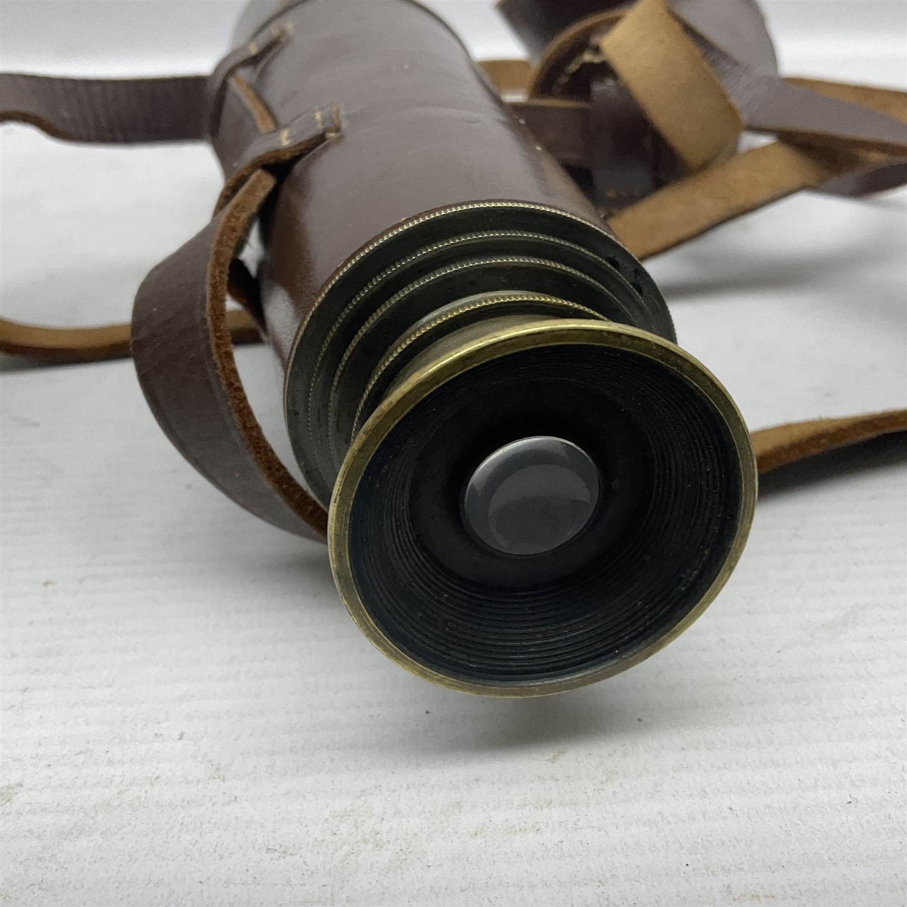 Broadhurst Clarkson brass and leather 4-draw telescope, the first draw with graduations, sliding lens shroud and leather covers for both ends on shoulder strap; marked 'Broadhurst Clarkson & Co. Ltd. 63 Farringdon Road London E.C.', L87cm fully extended; together with a WWI brass marching compass marked F-L No.123113 1918 (broad arrow); crudely etched L.H. McD. Latham; in associated Brooks & Co. leather case dated 1913 stamped W.B. Constable (2)