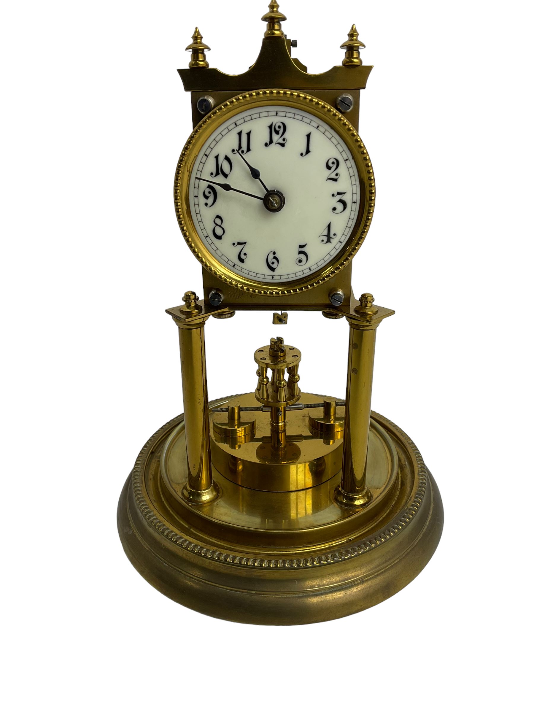 Gustav Becker - German Urania torsion clock with a glass dome, late 19th century 400-day movement with an enamel dial, arabic numerals and steel spade hands, movement supported by two brass pillars on a circular base, adjustable rotating pendulum with torsion suspension intact. With Key.