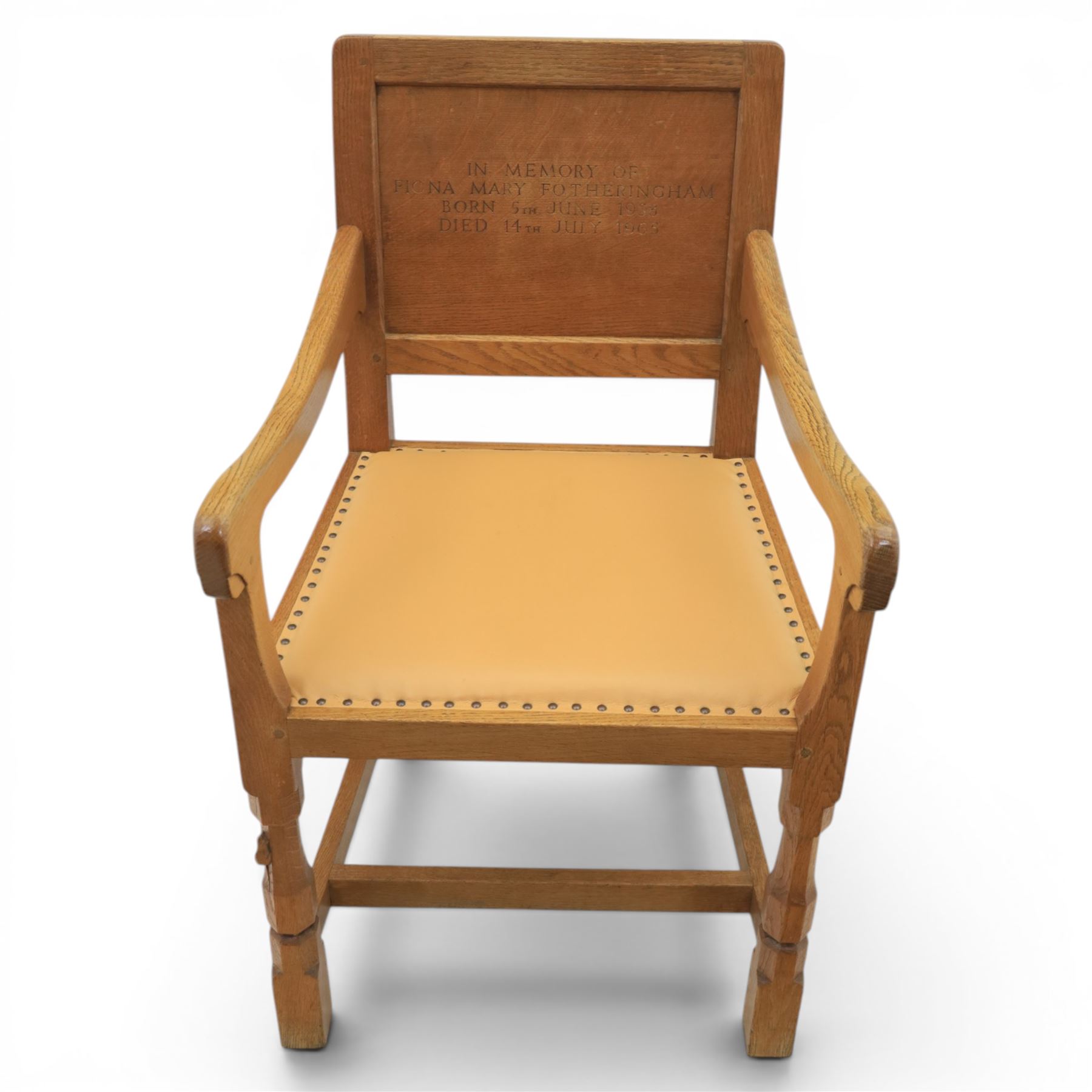 Mouseman - oak panel back carver armchair, with commemorative back panel engraved 'In memory of Fiona Mary Fotheringham Born 5th June 1958 Died 14th July 1965', above tan seat with brass studded trim, with carved Mouse signature, by Robert Thompson's of Kilburn