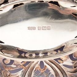 Edwardian silver oval dressing table box, the hinged cover embossed with angel heads W10cm London 1902 Maker William Comyns & Sons and an Edwardisn pierced silver oval sweetmeat basket L18cm Sheffield 1907 Maker James Dixon & Sons Ltd