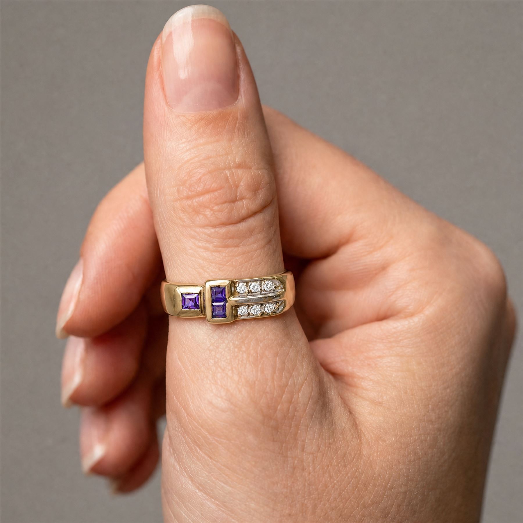 18ct gold purple sapphire and cubic zirconia dress ring, bezel set with three square cut sapphires and six cubic zirconia's, stamped 750