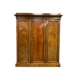 Victorian figured mahogany linen-press wardrobe, projecting cornice over triple panelled doors, left-hand side fitted with lien slides, two short and two long drawers, the right-hand door enclosing hanging space, plinth base