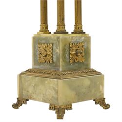 Neoclassical onyx and brass jardinière or plant stand, circular onyx top over an acanthus gilt frieze, supported by for fluted composite columns, square plinth with applied rosette mounts and stepped base, raised on scroll feet  
