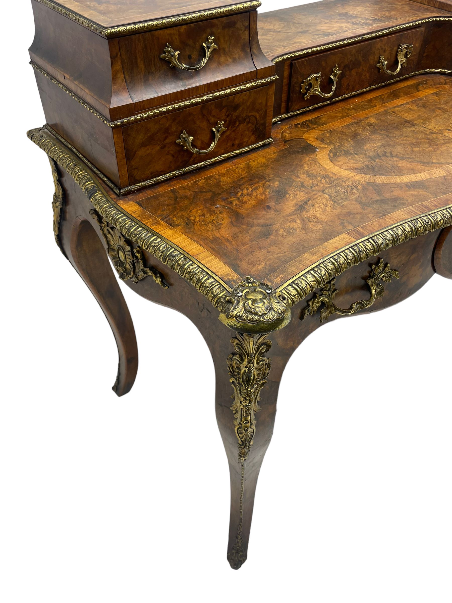 Late 19th to early 20th century French figured walnut writing desk, raised back fitted with drawers, shaped top with Kingwood banding and foliage cast edge moulding, fitted with single drawer, on cabriole supports mounted by shell and flower head cartouches 