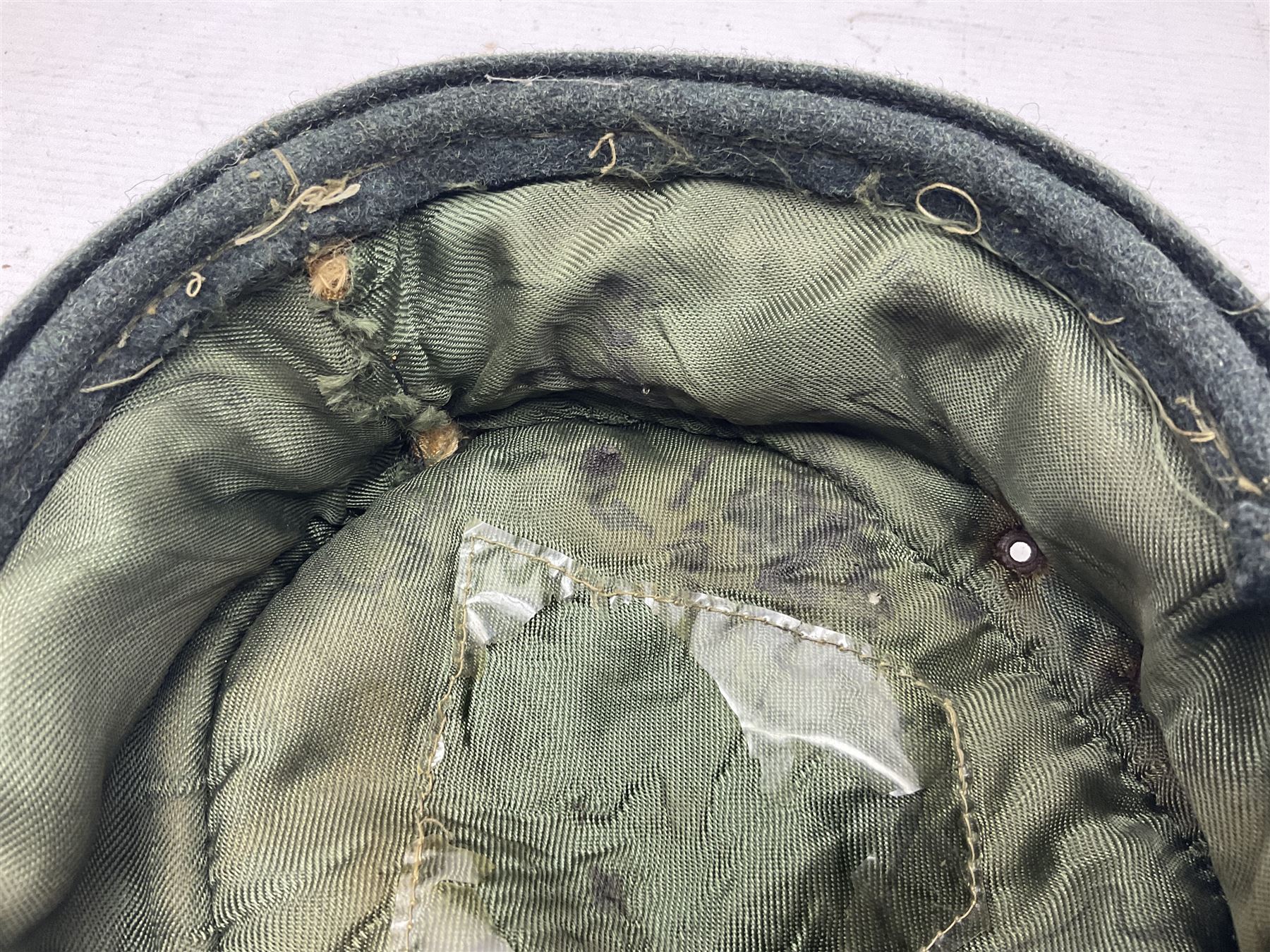 WWII German M43 field cap with 'SS' cloth badge and mountain trooper's edelweiss metal badge