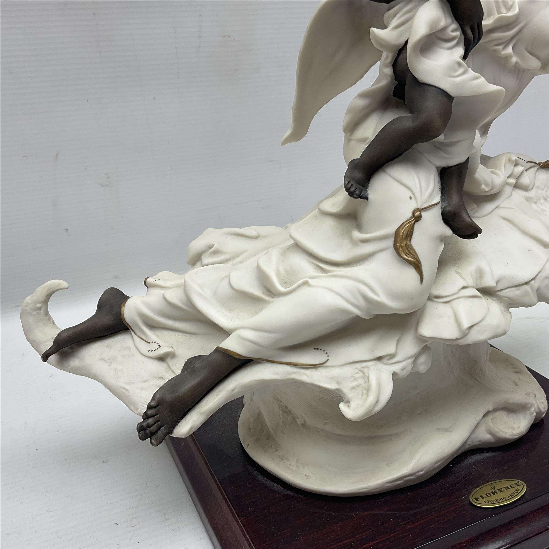 Giuseppe Armani Florence figure, Black Maternity, modelled as a mother and child upon a stylised cloud and mahogany base, H32cm