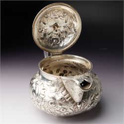 Matched three piece silver tea set comprising teapot of squat circular form London 1827,  milk jug of similar date and sugar bowl with Britannia standard marks, all with later embossed floral decoration and coat of arms, all marks rubbed