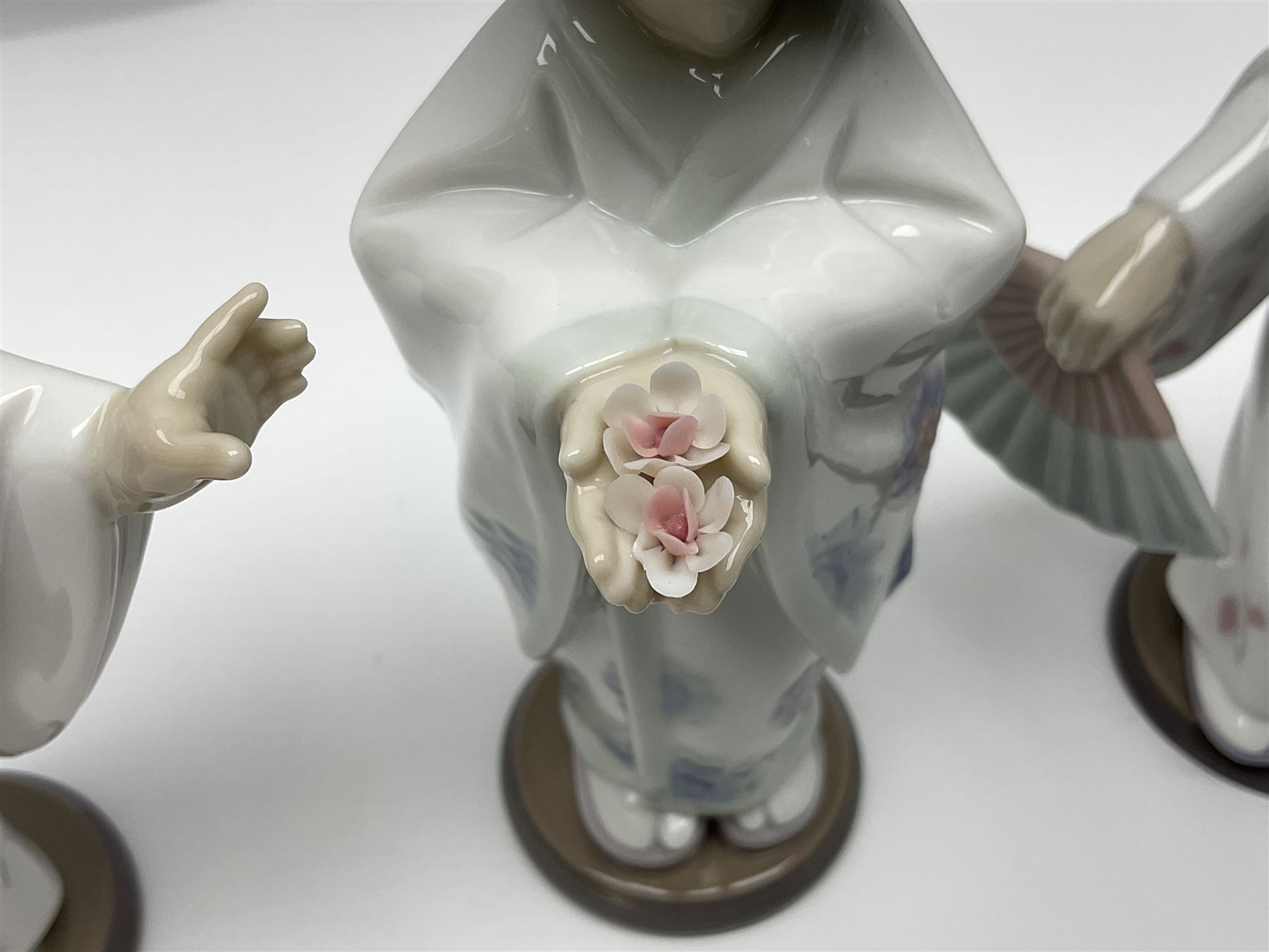 Six Lladro figures of the China doll set and Oriental doll set, comprising Playing the Flute no.6150, Bearing Flowers no.6151, Flower Gazer no. 6152, Oriental Dance no. 6230, Oriental Lantern no. 6231 and Oriental Beauty no. 6232, largest H20cm