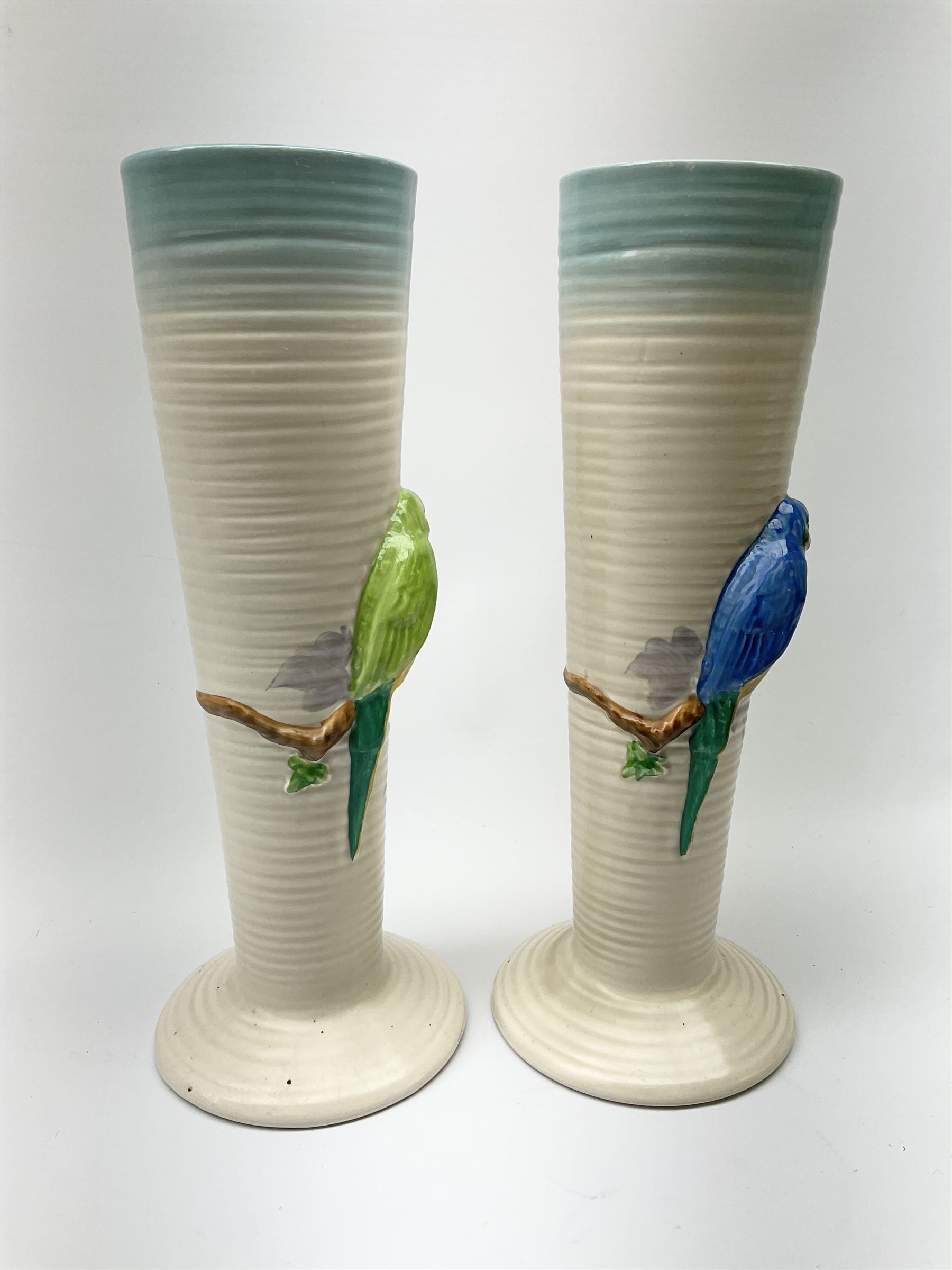 A pair of Clarice Cliff Newport Pottery vases, of tall ribbed conical