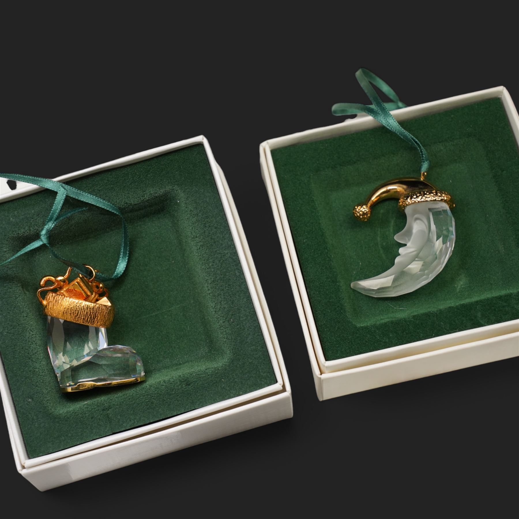 Twelve Swarovski crystal 'Christmas' and 'Crystal' Memories ornaments, comprising Moon, Sun, Boot, Candy Cane, Christmas Wreath, Pinecone and Holly etc, boxed and with sleeves (12)