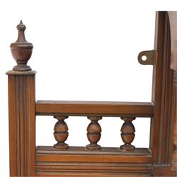 Edwardian walnut overmantel mirror, moulded cornice over three arched apertures with turned supports, flanked by open shelves with turned uprights and finials, carved foliate panels to the base