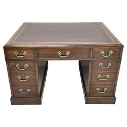 George III mahogany twin pedestal partner's desk, moulded rectangular caddy top with tooled leather inset, one side fitted with nine drawers and the opposing side fitted with single drawer, two false drawers and two panelled cupboards, ornate cast gilt metal handles and handle plates, on plinth base
