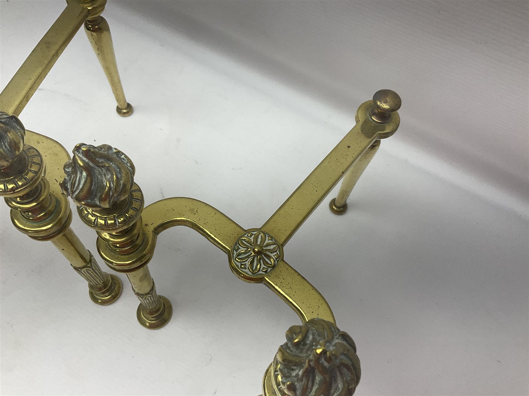 Early 20th century brass coal bucket with pierced sides, upon three pad feet, together with a pair of brass fire dogs, with flambe finials, coal bucket H27cm